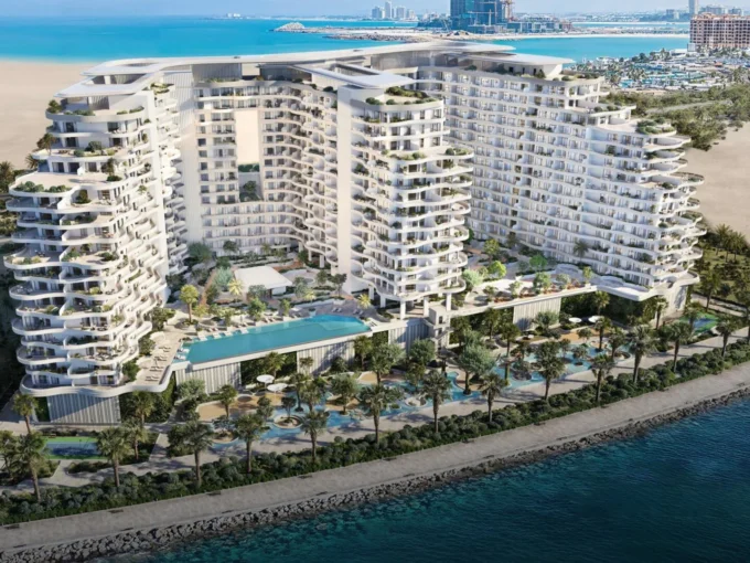 Aerial view of Miraggio, a luxury beachfront development with curved towers and infinity pools