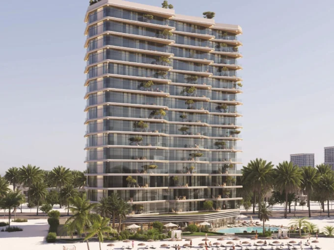 A tall, modern building, "The Beach Vista," with balconies and greenery, overlooks a sandy beach with palm trees and a pool.