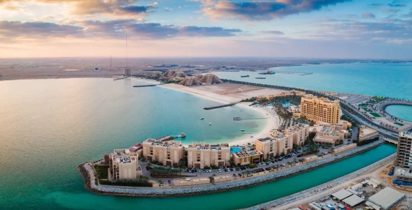 Aerial view of Al Marjan Island, a man-made archipelago, with luxury resorts and beaches.